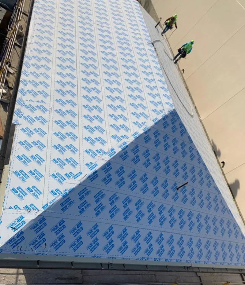 Professional roofers installing underlayment on a metal roof in Haverstraw